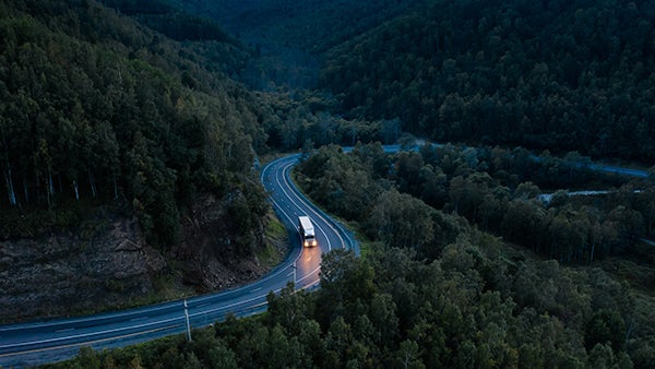 Truck on a winding road at dusk, representing next day shipping to Canada.